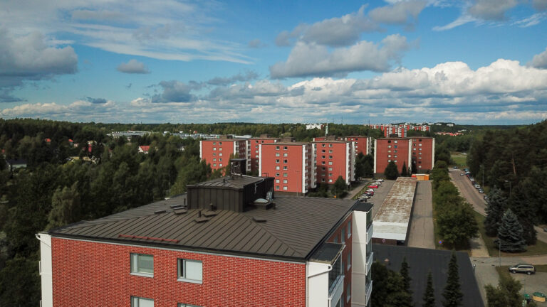 Red apartment buildings pictured with a drone